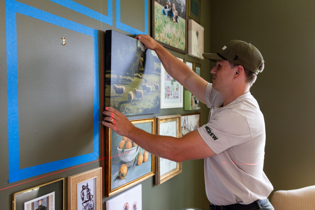 Person Hanging Picture Frame